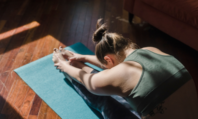  A woman preventing injuries by stretching 