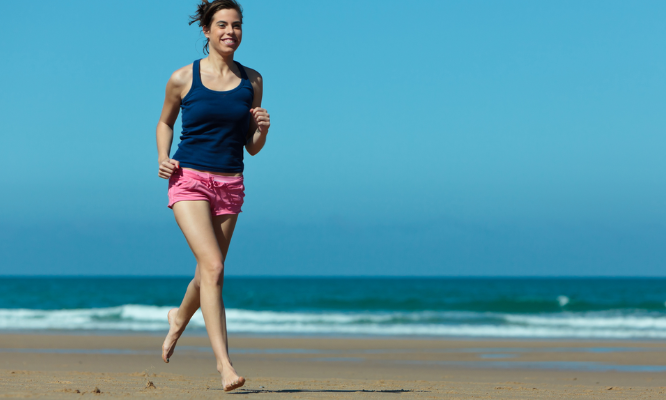 woman running along the coast