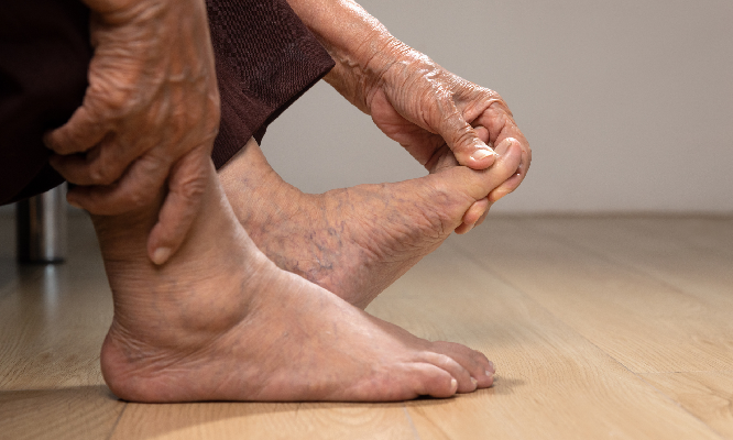 man looking at leg exercises pain and discomfort by toe buinons
