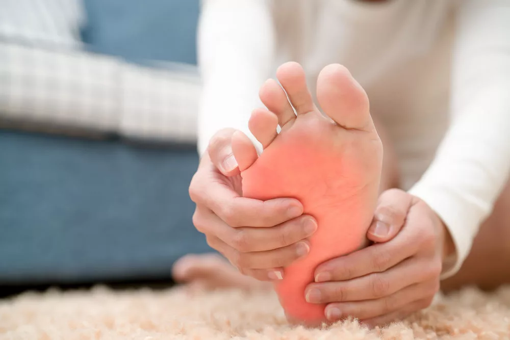 women touch her foot painful